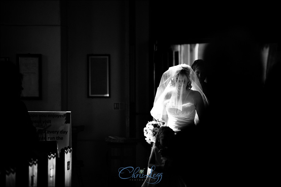 Black and white shot of bride walking up the aisle