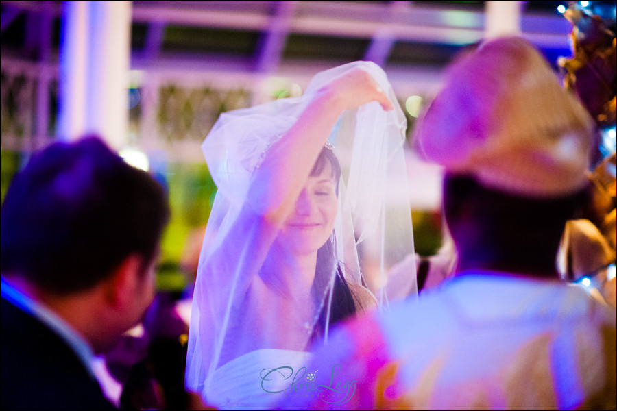 Colour shot of russian bride dancing with a veil over her face