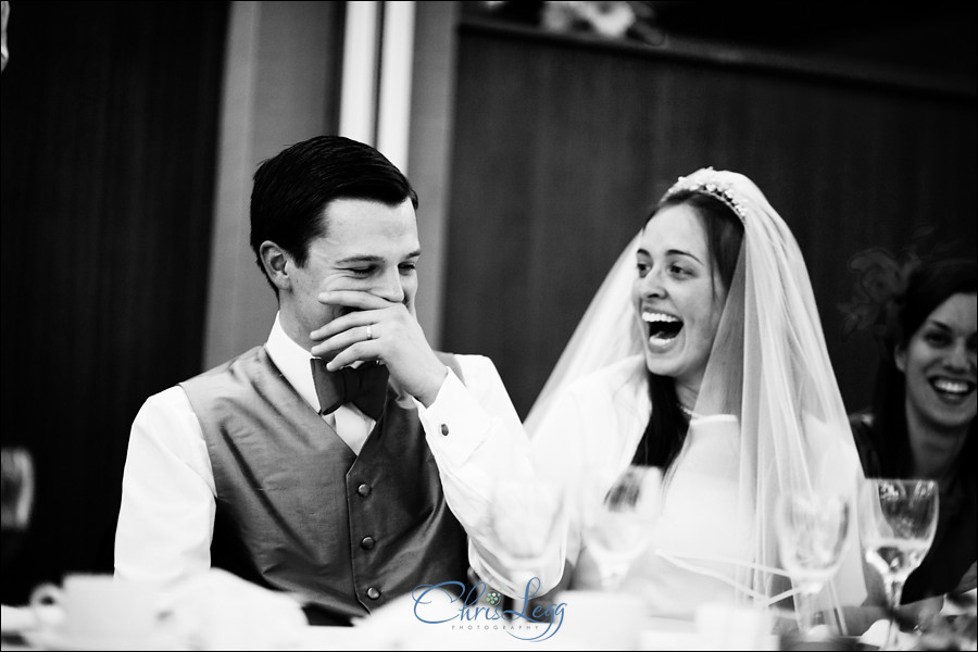 Bride and groom laugh during the speeches